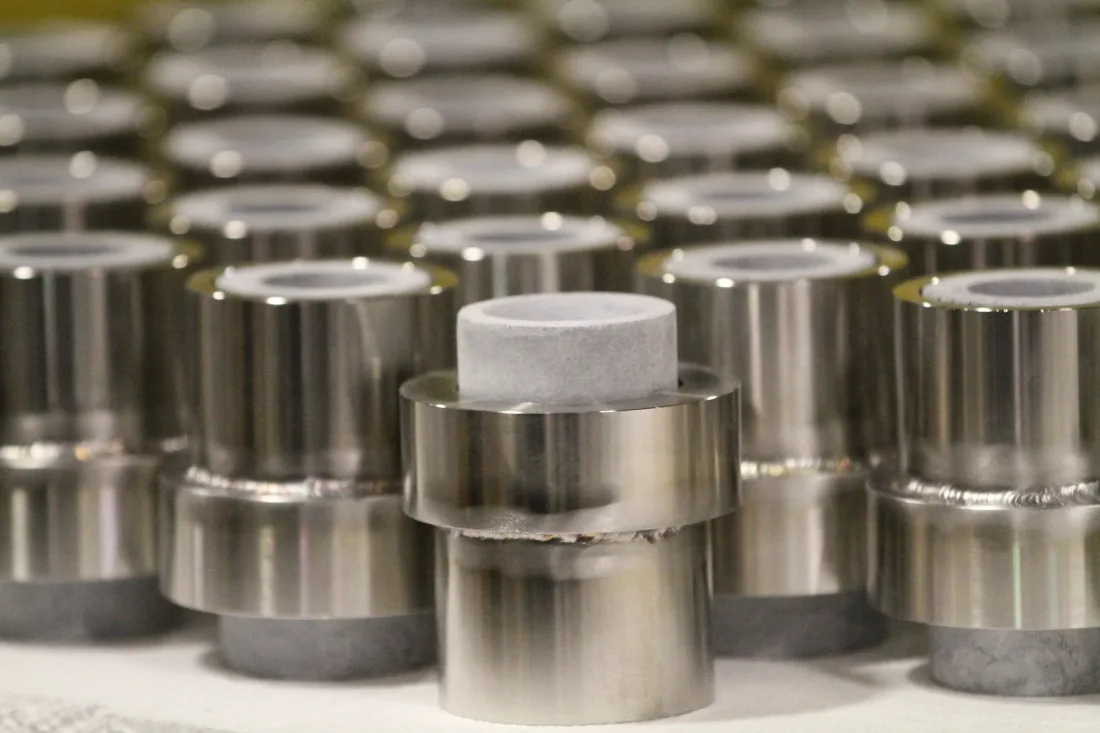 Ceramic nozzle inserts welded into polished steel sleeves