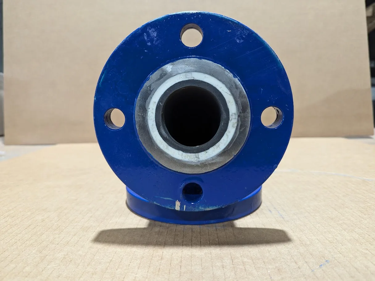 End view of a ceramic lined elbow, liner and flange holes