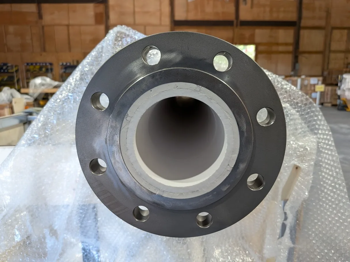 Large flanged spool with a thick white ceramic liner