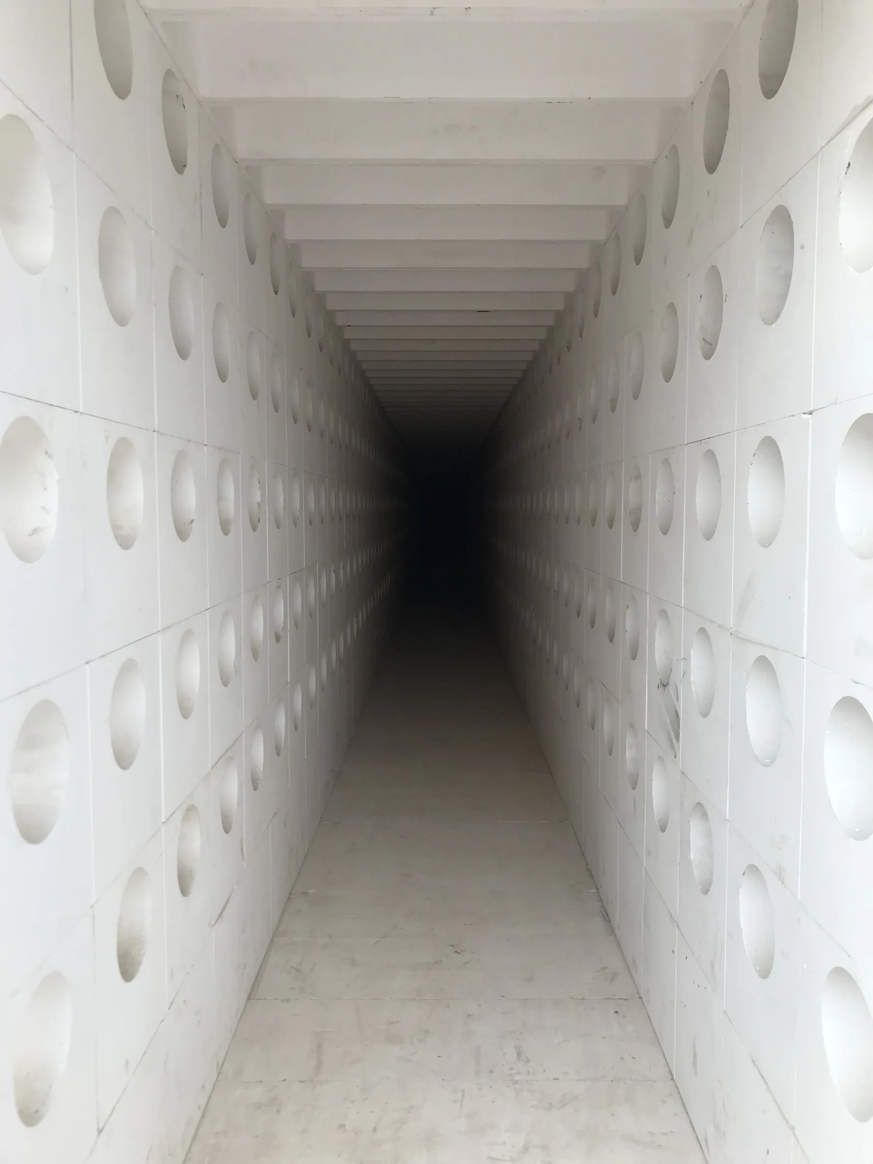 Inside a finished precast flue gas tunnel with rows of round side openings